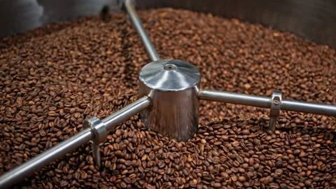 Top view of roasted coffee beans cooling in an industrial roaster tray. Stock Footage 327395200