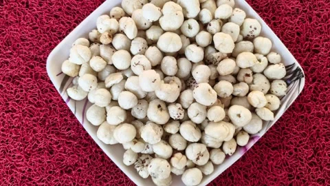 Top view of roasted fox nuts or makhana in a white bowl Видео 326988594
