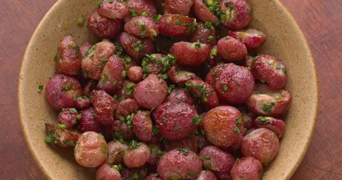 Top view of roasted radishes with dill and chives. Stockbeeldmateriaal 340605119