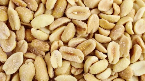 Top view of roasted salted peeled peanut nuts circle rotation Stock Footage 233443922