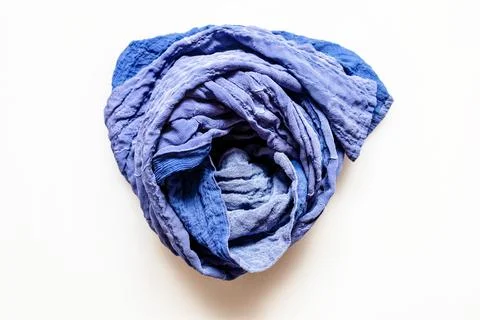 Top view of rolled blue patchwork scarf on white Stock Photos