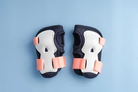 Top view of roller skates protective gear set - wrist pads in pink colors. Blue Stock Photos
