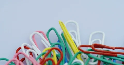Top view on the rolling paper clips in colours lying on the white background Stock Footage 86538969