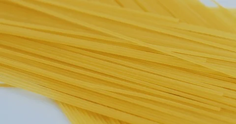 Top view on the rolling spaghetti lying on the white background. Macro shooting Stock Footage 86538525