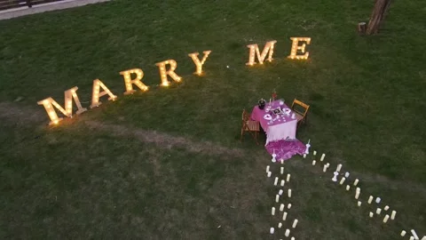 Top view of the romantic dinner behind which is the inscription marry me Stock Footage 157753976
