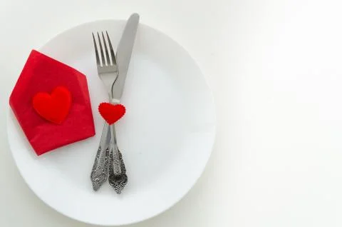 Top view romantic dinner proposal concept. Dish with cutlery and red gift box Stock Photos