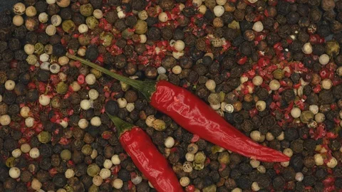 Top View Rotating Of Dried Red Chili Peppers With Multi Color Peppercorns On A B Stock Footage 128628932