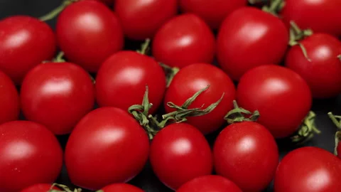 Top View Of Rotating Fresh Red Cherry Tomatoes On A Black Plate. Cherry Tomatoes Stock Footage 150824463