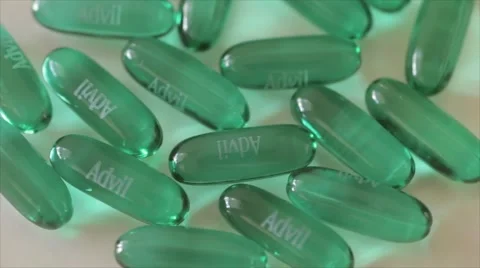 Top view of rotating pills of Advil Stock Footage 55862501