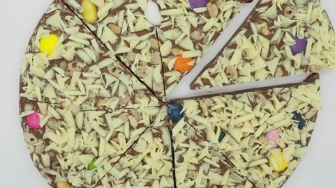 Top View Of A Rotating Pizza Shaped Chocolate. London, UK Vídeos de archivo 133120914