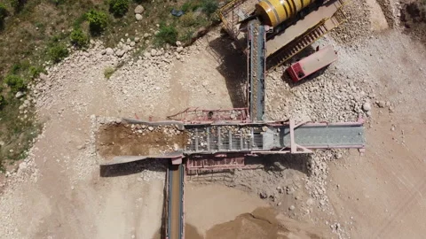 Top view rotating of a screening machine classifying aggregates Stock Footage 196890520