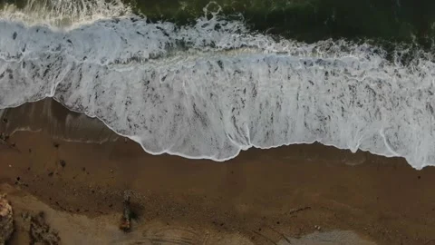 Top view with rotation in a circle on the sea surf on yellow sand Video stock 151145930