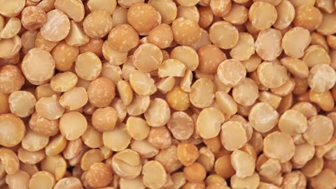 Top view of rotation dried yellow peas. Round yellow peas for cooking porridge Stock Footage 284618073
