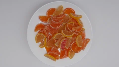 Top View Of Rotation Of Sweet Colored Slices Of Marmalade Stock Footage 147742316