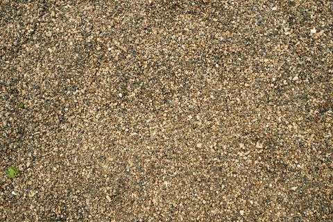 Top view of rough ground aggregate sand with minor soil disturbances, ideal f Stock Photos