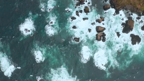 Top view of rough seas. Waves rush on coastal rocks into white splashes. Aerial 库存影片 118017126