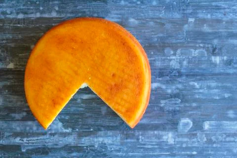 Top view of round cheese missing a piece Stock Photos