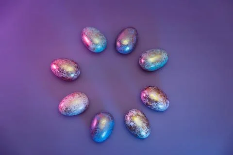 Top view round frame made of Easter golden eggs with different patterns in neon Stock Photos