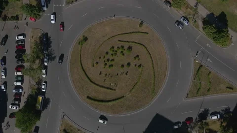 Top view of a roundabout with traffic moving through it, busy city, 4k Stock Footage 163895437