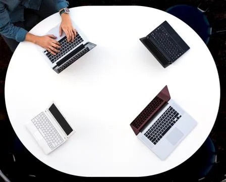 Top View of Rounded Desk with Four Laptops Stock Photos