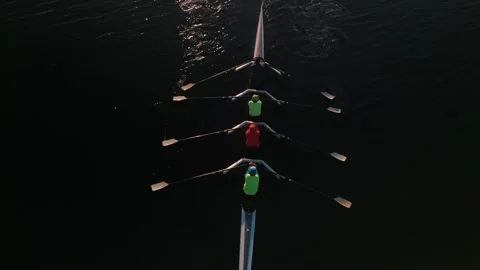 Top View of Rowers on Four-oar Rowing Boats Calm Ocean at Sunrise Stock Footage 256262948