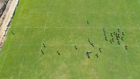 Top view of a rugby game. Athletes compete on a large green field. Sports Stock Footage 268901892