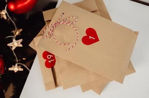 Top view on rustic advent calendar bags with small gifts for christmas eve Stock Photos