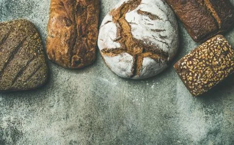 Top view of rustic bread loaves over grey background Stock Photos