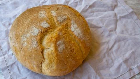 Top view on rustic bread on a natural linen napkin. Stock Photos