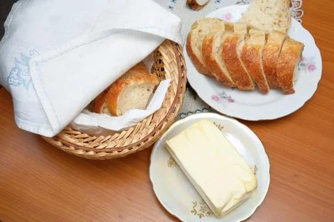 Top view of rustic breakfast table setting with fresh butter and sliced bread Stock Photos
