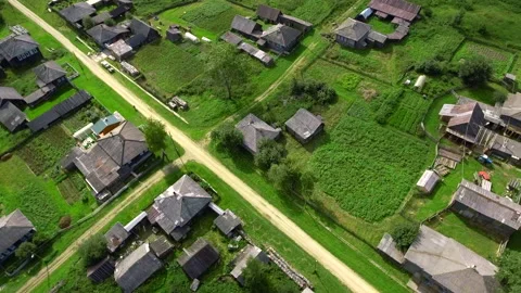 Top view of rustic cottages with green fields. Stock footage. Neat plots of Stock Footage 219821087