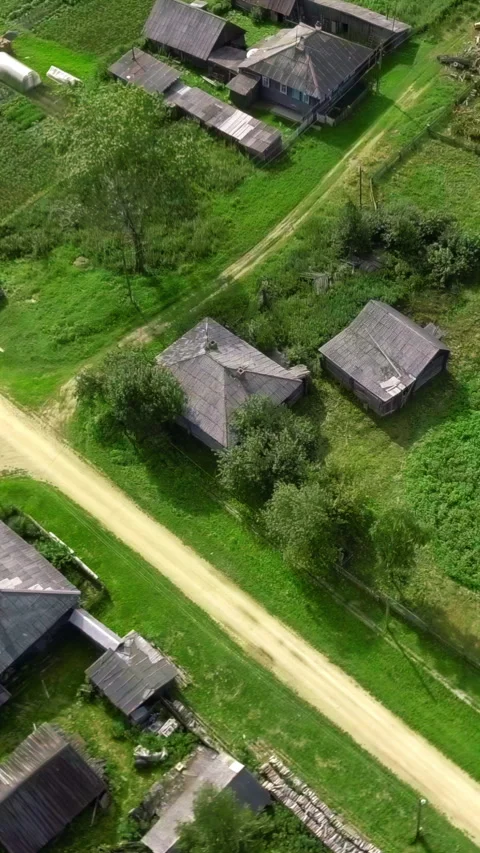 Top view of rustic cottages with green fields. Stock footage. Neat plots of Stock Footage 283299033