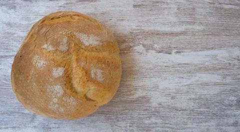 Top view on rustic home bread on a wooden background Stock Photos