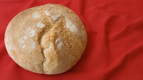 Top view on rustic home bread on a red background. Stock Photos