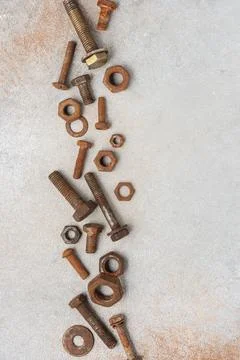 Top view of rusty wrenches, bolts, nuts and screws arranged on light textured 库存照片