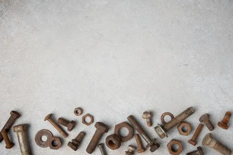 Top view of rusty wrenches, bolts, nuts and screws arranged on light textured 写真素材