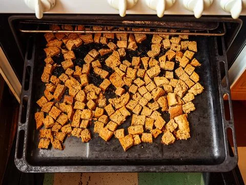 Top view of rye bread cut into cubes on oven tray Stock Photos