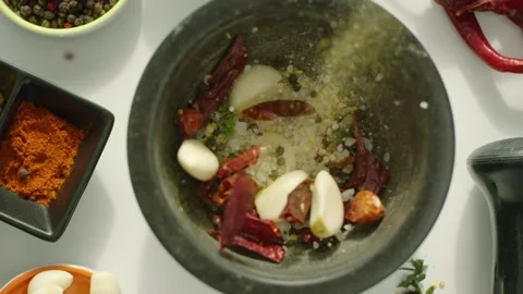 Top View Salt Dried Chili and Garlic Falling into Stone Mortar with Spices 4K Vídeos de archivo 347364403