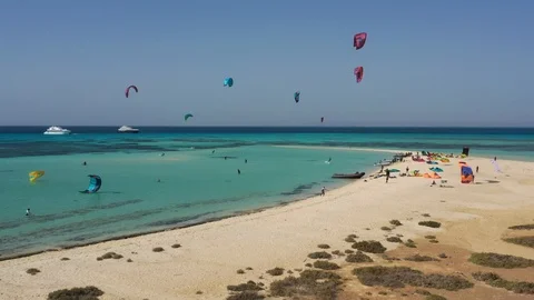 Top view of a sandy beach and red sea with kiteboarders and kites, Egypt Stock Footage