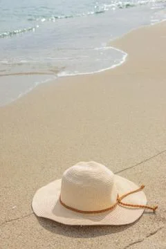 Top view of sandy beach with summer hat. Blank mock up for advertising or Stock Photos