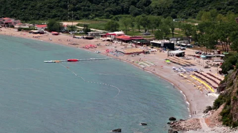 Top view at the sandy Jaz beach with sunbeds and parasols and azure Adriatic sea Stock Footage 69030859