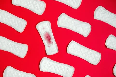 Top view sanitary pads pattern  on a vibrant  red background Stock Photos