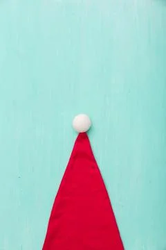 Top view on Santa's hat on retro wooden turquoise background. Christmas, wint Stock Photos