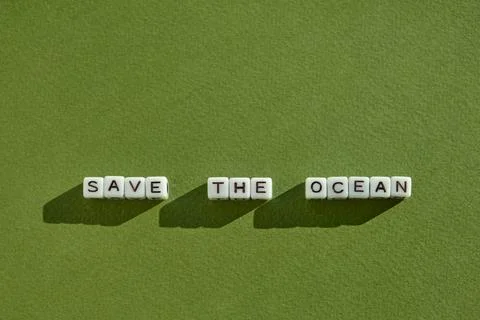 Top view of "Save the ocean" lined with white cubes lettering modern eco tr.. Stock Photos