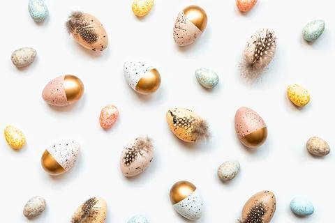Top view of scattered Easter eggs colored with golden paint in different pa.. Stock Photos