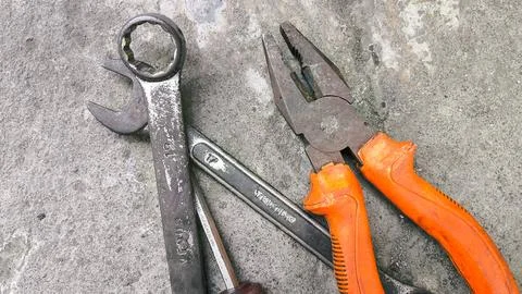 Top view of scattered hand tools on gray cement background with space for t.. Stock Photos