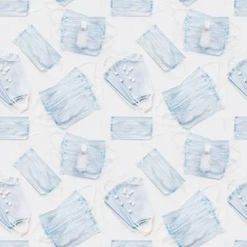 Top view on scattering blue protective medical masks, sanitizer gel and scatt Stock Photos