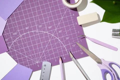 Top view of scrapbooking tools, scissors, and craft knife on a purple cutti.. Stock Photos