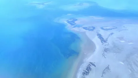 Top view of the sea or ocean from an airplane window. Air travel and tourism. Stock Footage 274907655