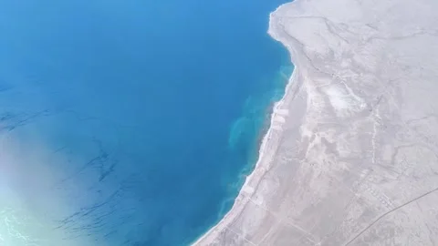 Top view of the sea or ocean from an airplane window. Air travel and tourism. 스톡 동영상 276947557